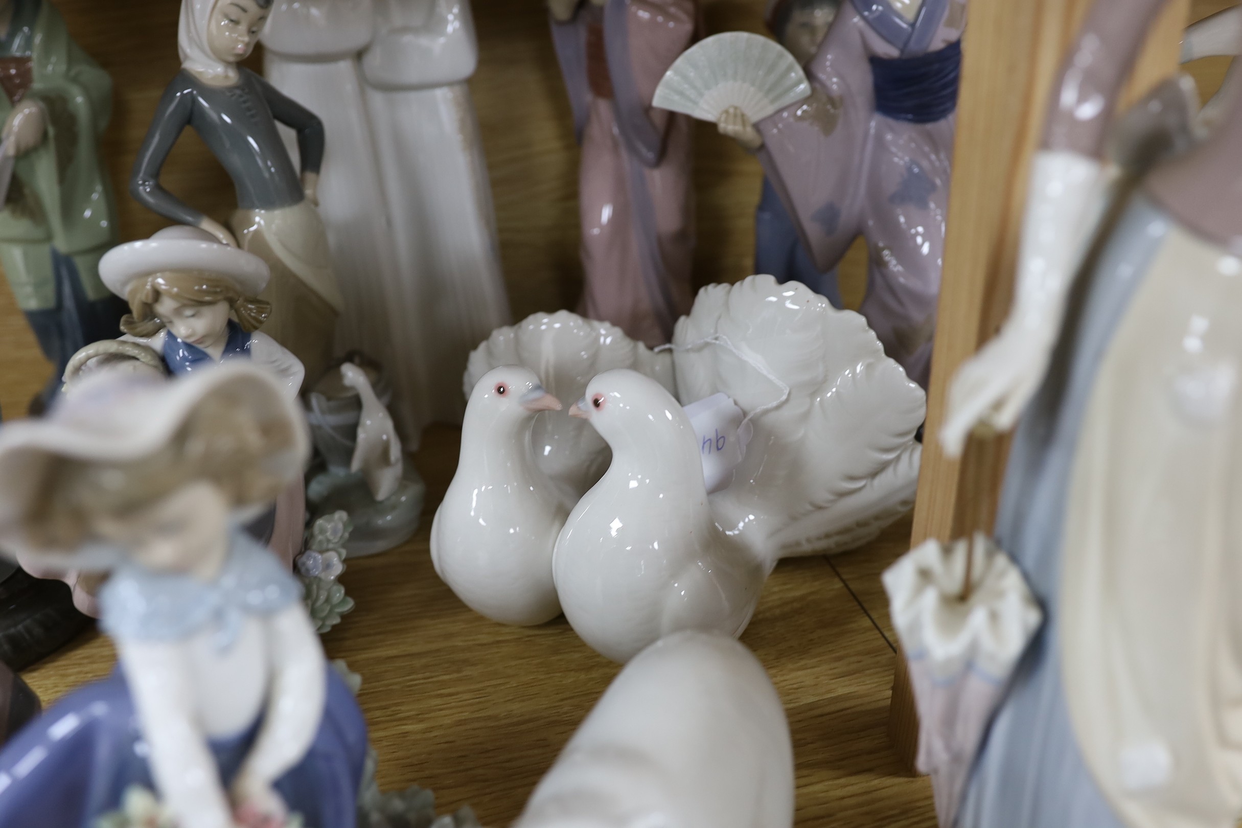 A selection of fifteen Lladro figures, tallest 35cm